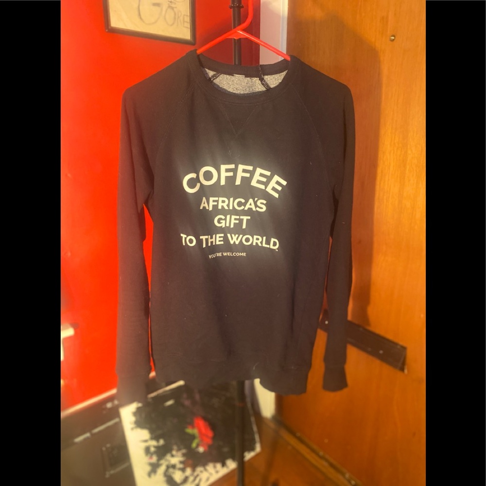 Black Sweatshirt w odd coffee slogan.
